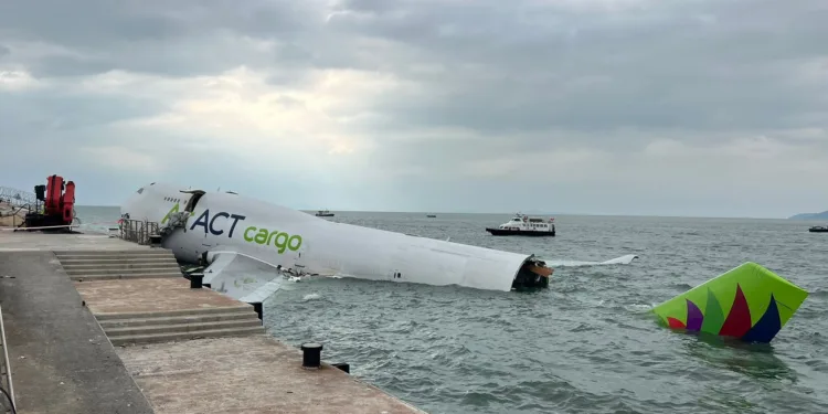 Emirates-leased cargo jet skids off Hong Kong runway, killing 2 in vehicle