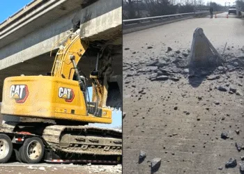 Flatbed truck hauling excavator shuts down Kansas bridge