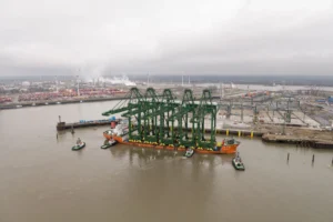 The 5 new cranes are moored at PSA Antwerp's Europa Terminal with Project Emerald in the background.
